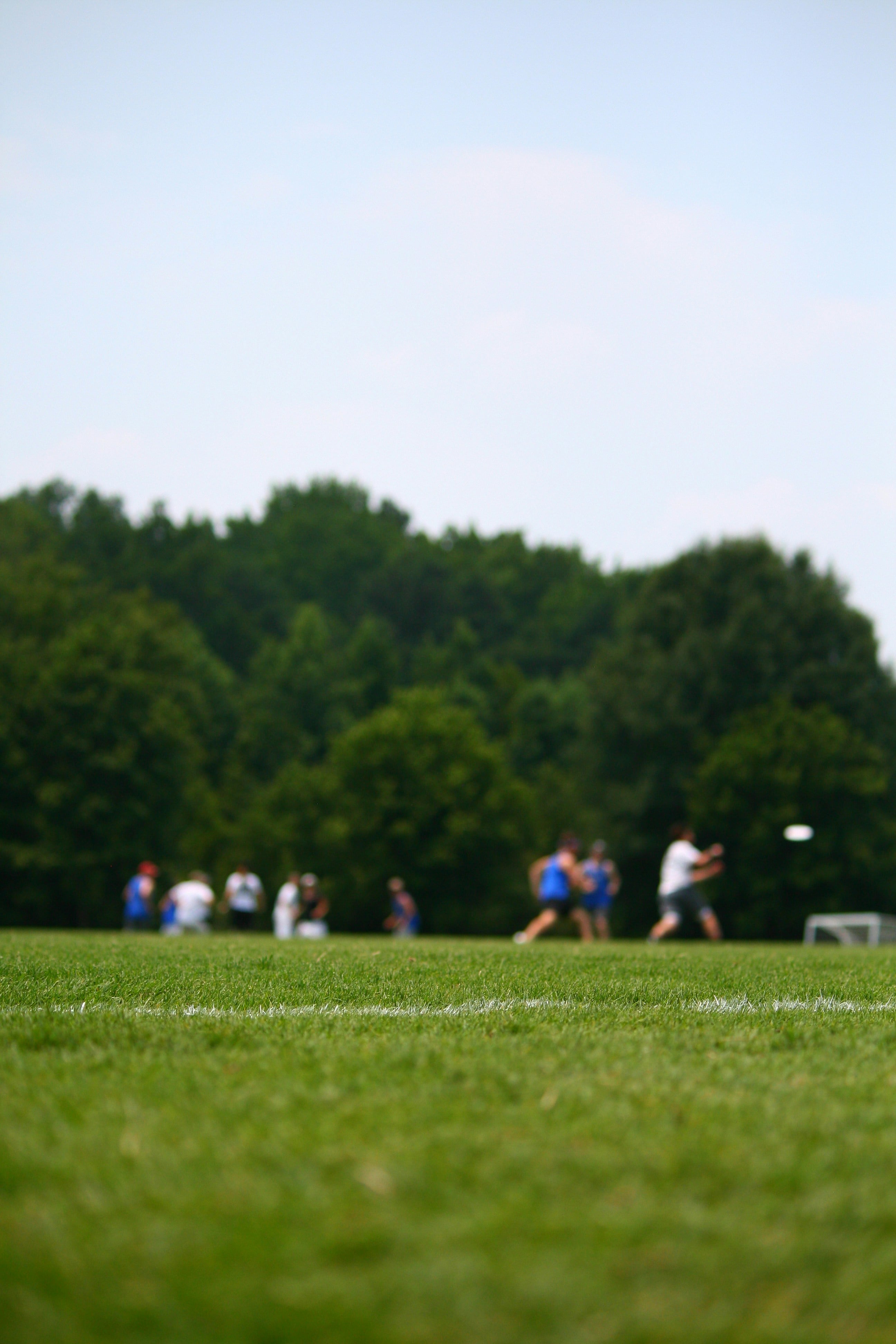 Ultimate frisbee field action. Photo by Zack Hann on Unsplash